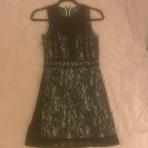 Disney Branded black lace dress with a second beige/tan layer underneath .